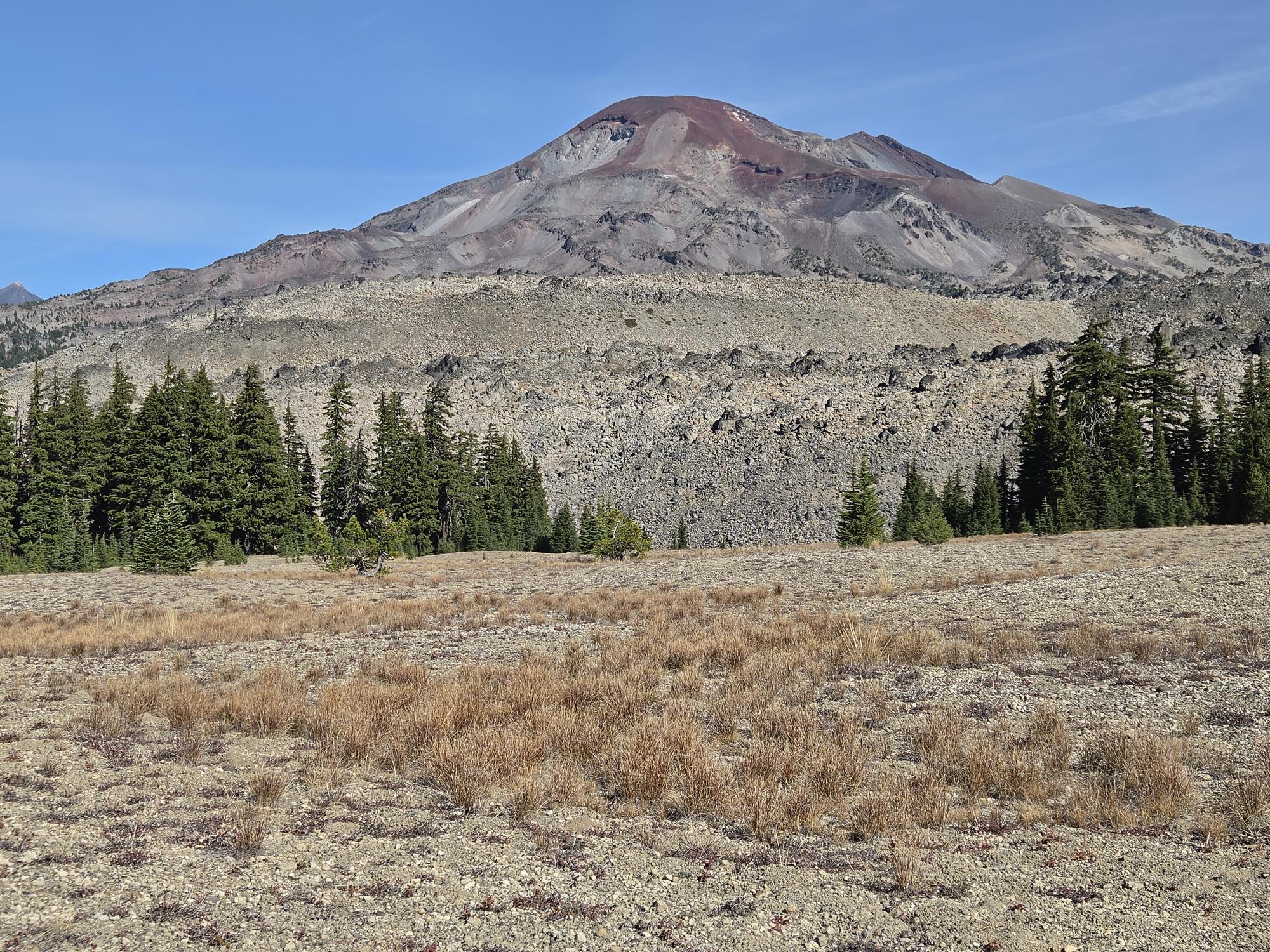 South Sister dominates the view across Wickiup Plains. Alt text: South Sister rising above open Wickiup Plains under a clear blue sky.
